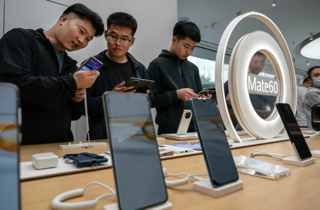 People look at newly launched smartphones at a Huawei flagship store